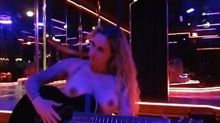 Without Bra Playing Guitar And Singing In Unclothe Club